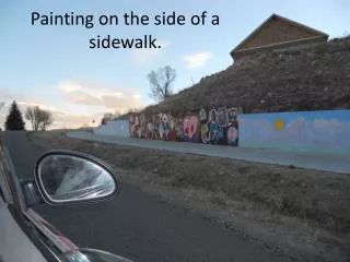 Painting on the side of a sidewalk.